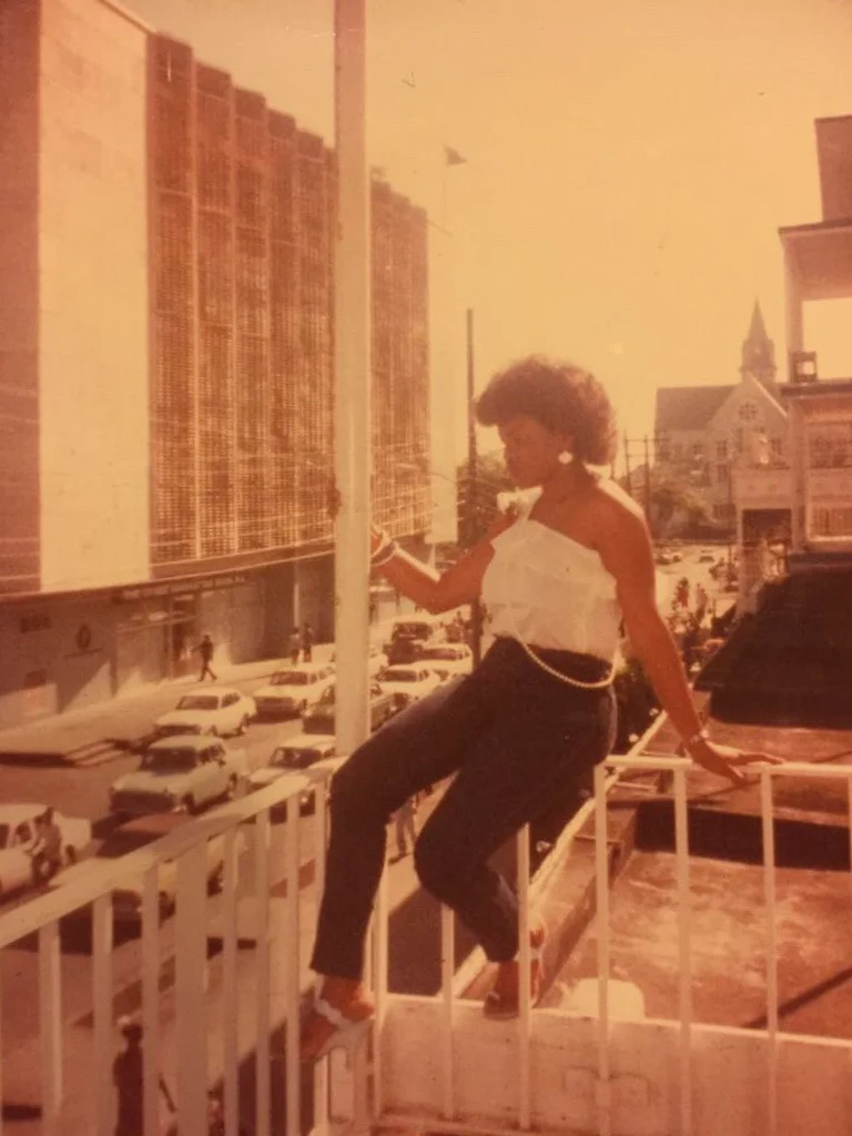 Mom sitting on the veranda of the Post Office in Guyana overlooking St. George's Cathedral as well as the Bank of Guyana.