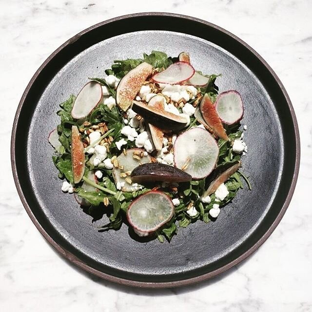 Special salad for tonight (or until we run out of these amazing fresh figs!). Arugula, local radishes, ch&egrave;vre and puffed farro with a pickled garlic scape and honey vinaigrette. ✨