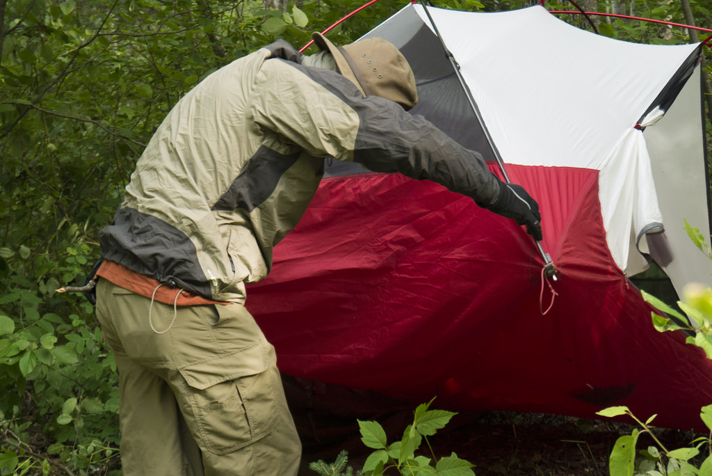 Jason attempting to rid Matt's tent of hornets - much to his frustration.
