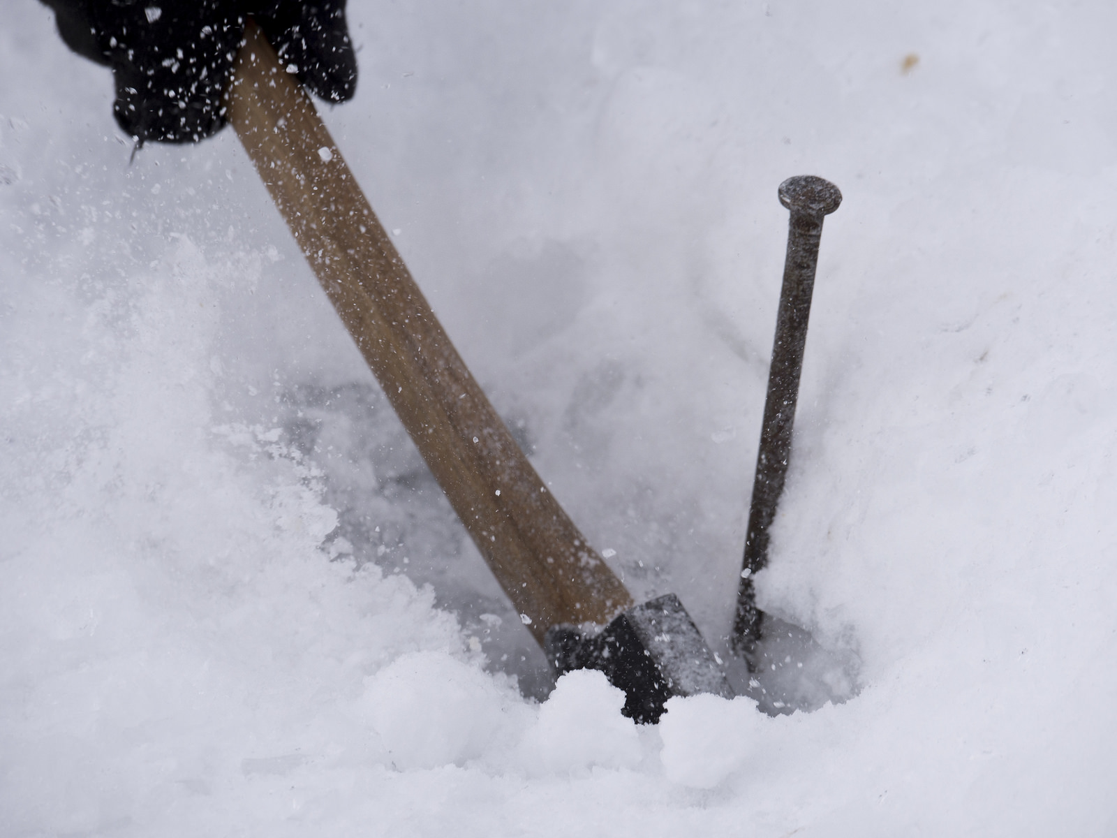 Testing the thickness of the ice and the resilience of our tent pegs.