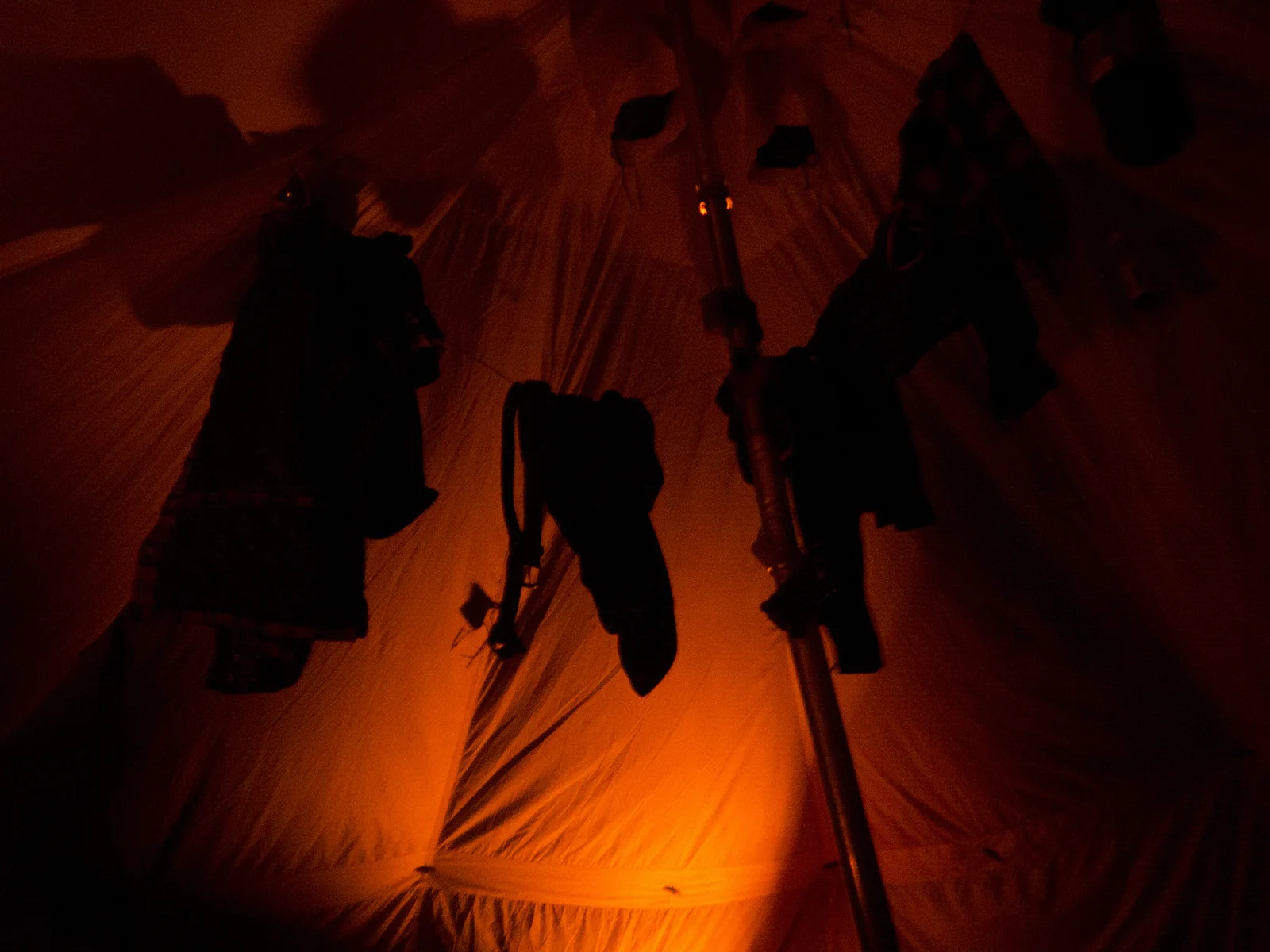 Hanging our gear to dry inside the canvas tent. We turn off the propane heaters before sleeping, turning them on only for short intervals throughout the night.