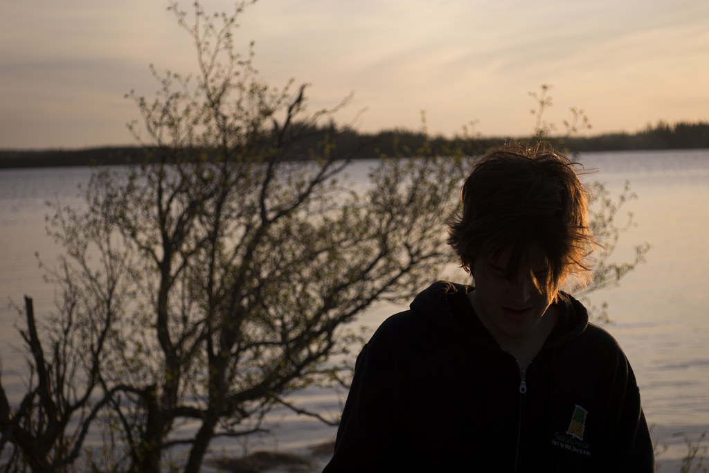 Drying off on the shore after capsizing a canoe.