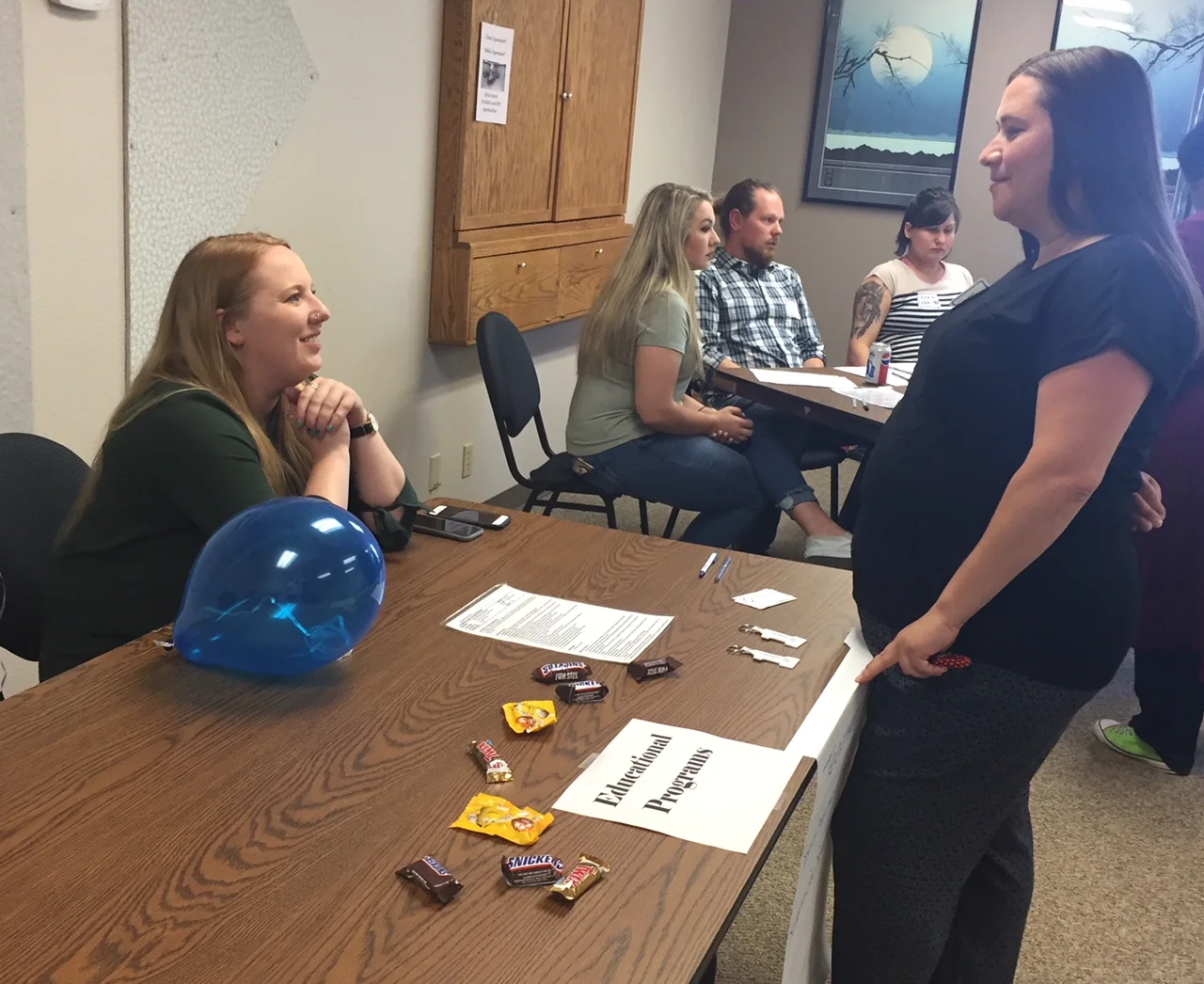 Riverfront School's Brianna Vincent talks with a job fair attendee at the 2018 Looking Glass job fair held at the Administrative offices on Thursday, June 7, 2018.