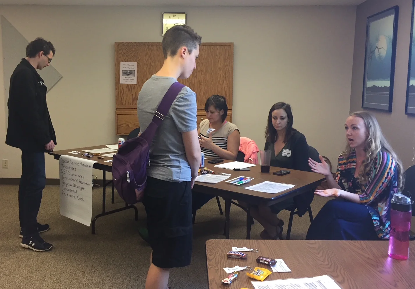 Residential Services Director, Maleigha Myers, talks with a job fair attendee about her position openings.