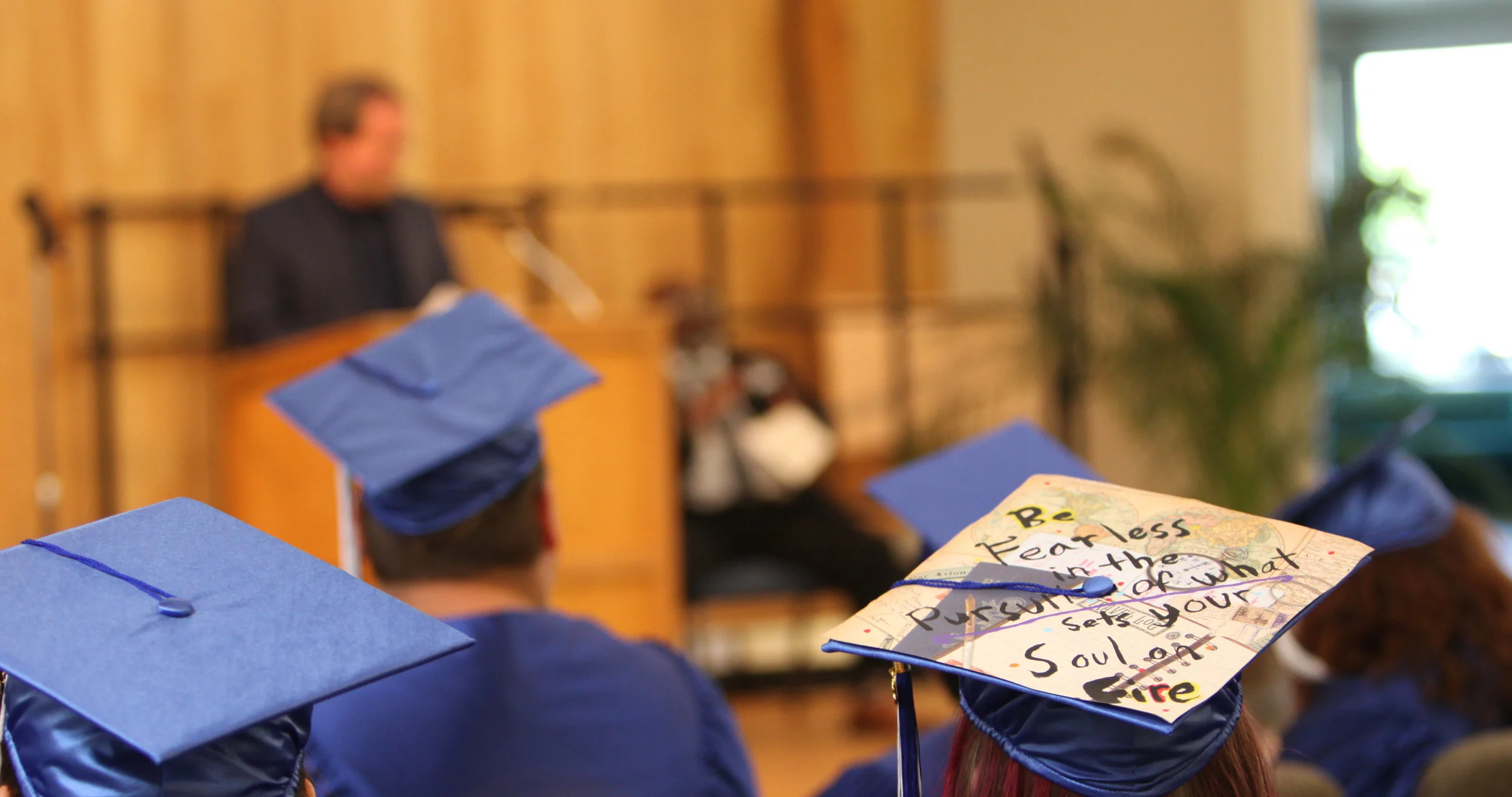 Atop a graduation cap of one of the Looking Glass Riverfront alternative school graduates is written "Be fearless in the pursuit of what sets your soul on fire."