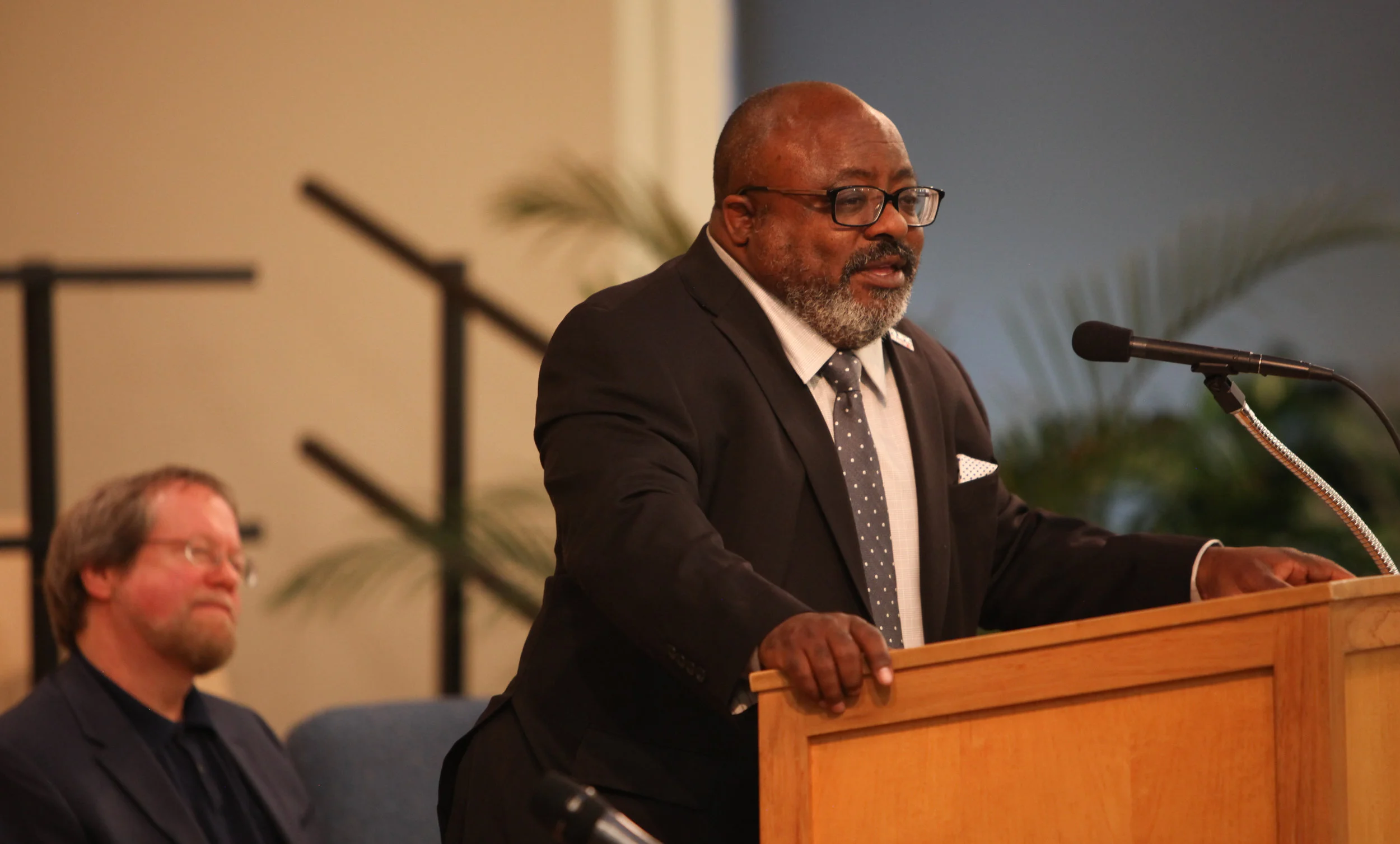 Commencement speaker Greg Evans addresses the Riverfront school graduates while Looking Glass CEO Craig Opperman looks on.