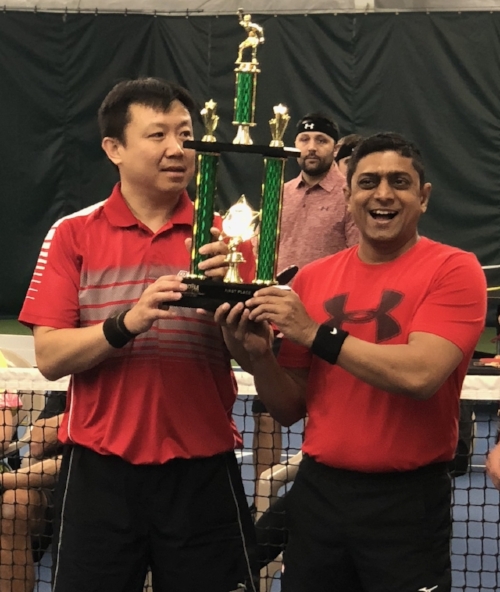 Paddle Battle 2018 Champions Tian Wei Chen (left) and Samir Patel embrace their 1st place trophy after their hard fought victory over team Ping Pow!