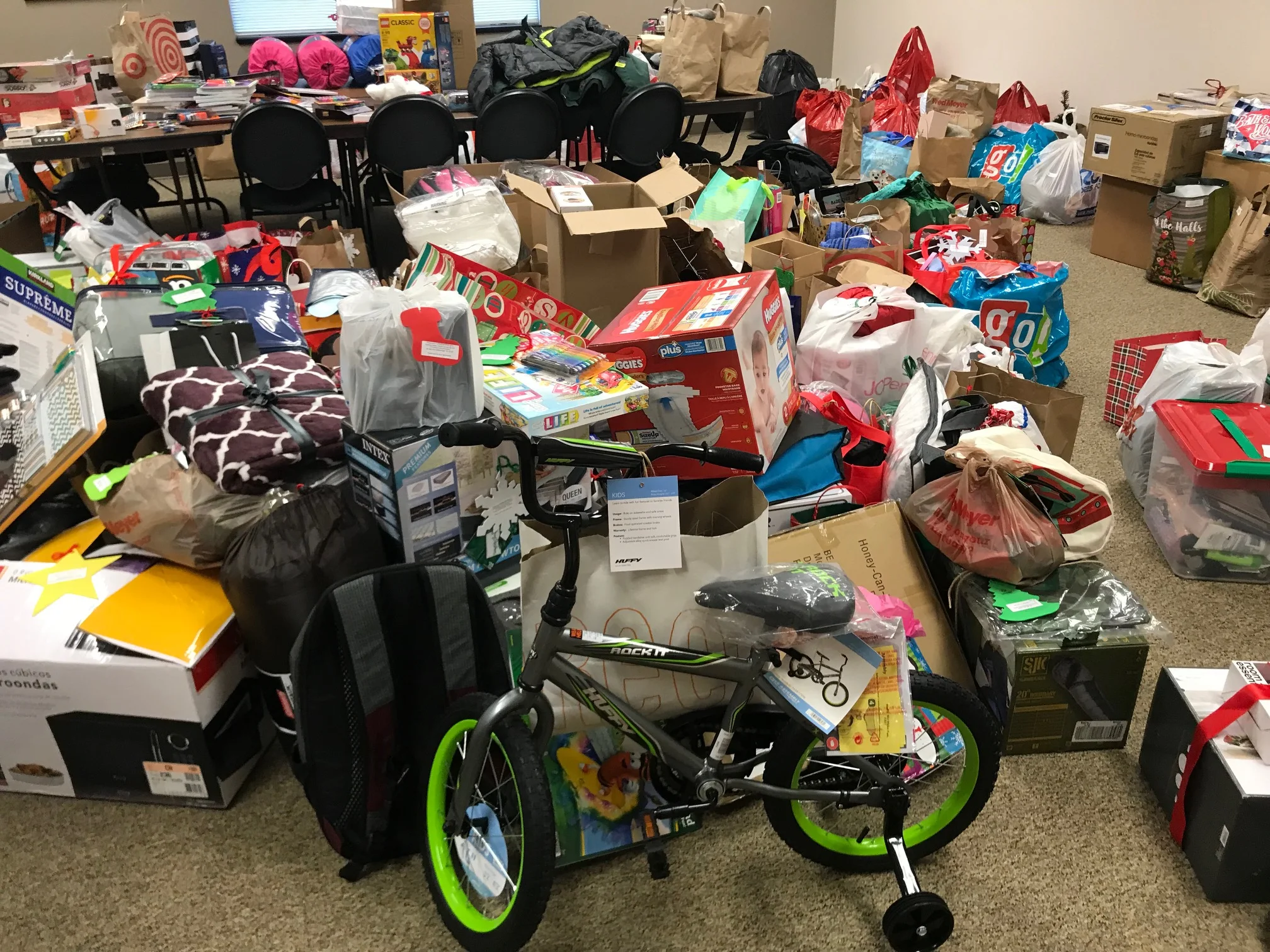 Giving Tree donations pack the conference room at Looking Glass’ Admin offices
