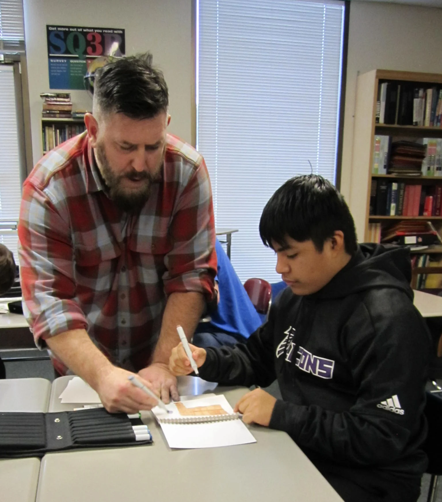 Imagination International Graphic Artist Matt Brundage shows some of his drawing techniques to Center Point students.