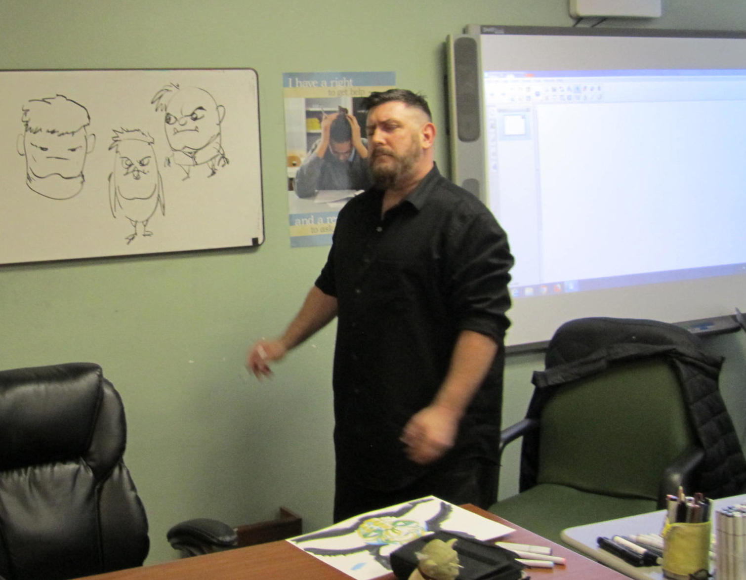 Matt illustrates some of his facial drawing techniques on the white board at Center Point School.