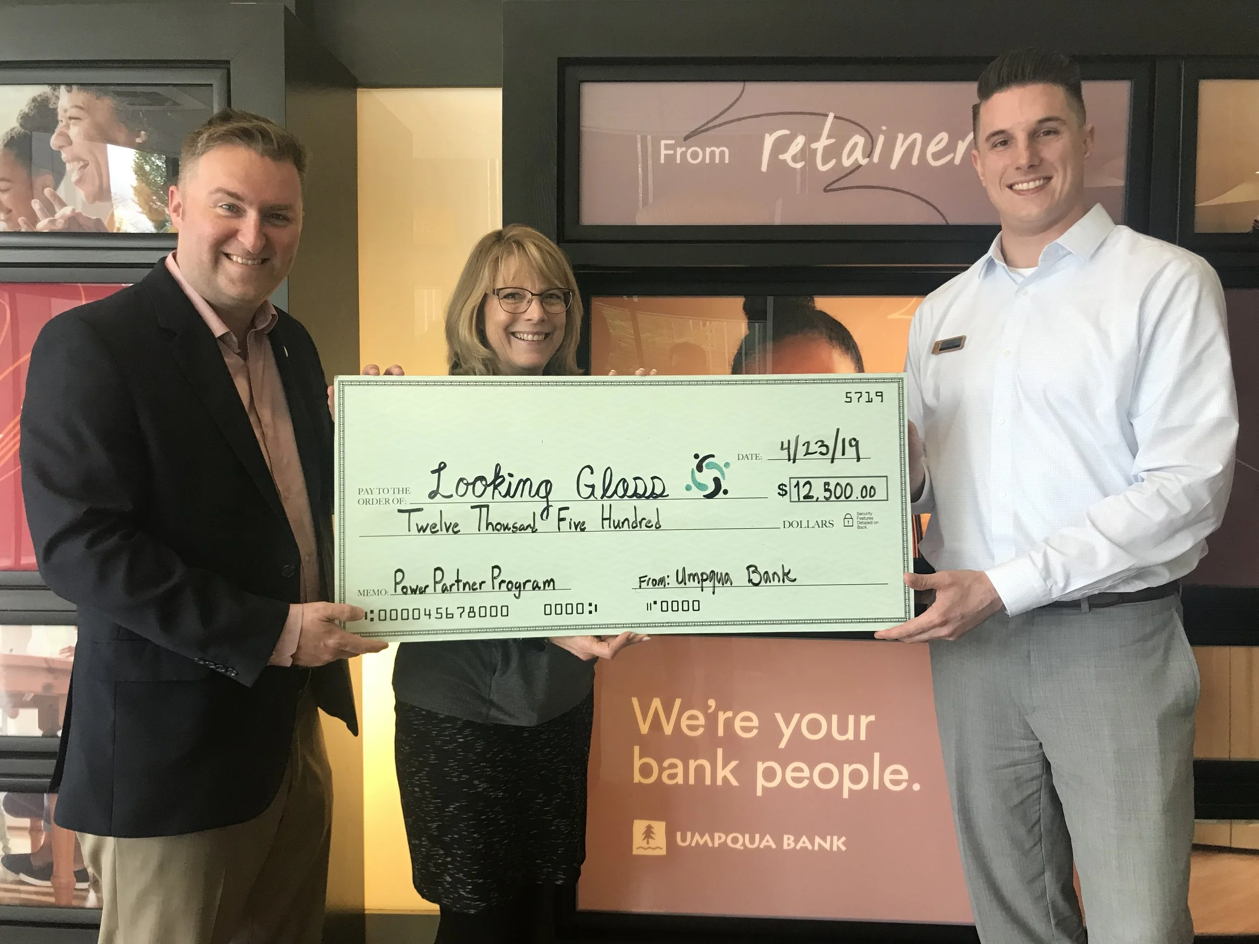 From left: Looking Glass Marketing & Development Director Tyler Mack, downtown Umpqua Bank branch manager Karen Nielson and Umpqua Commercial Banking Relationship Manager Scott Fagan display Umpqua’s $12,500 check donated as part of the Power Partner Program.