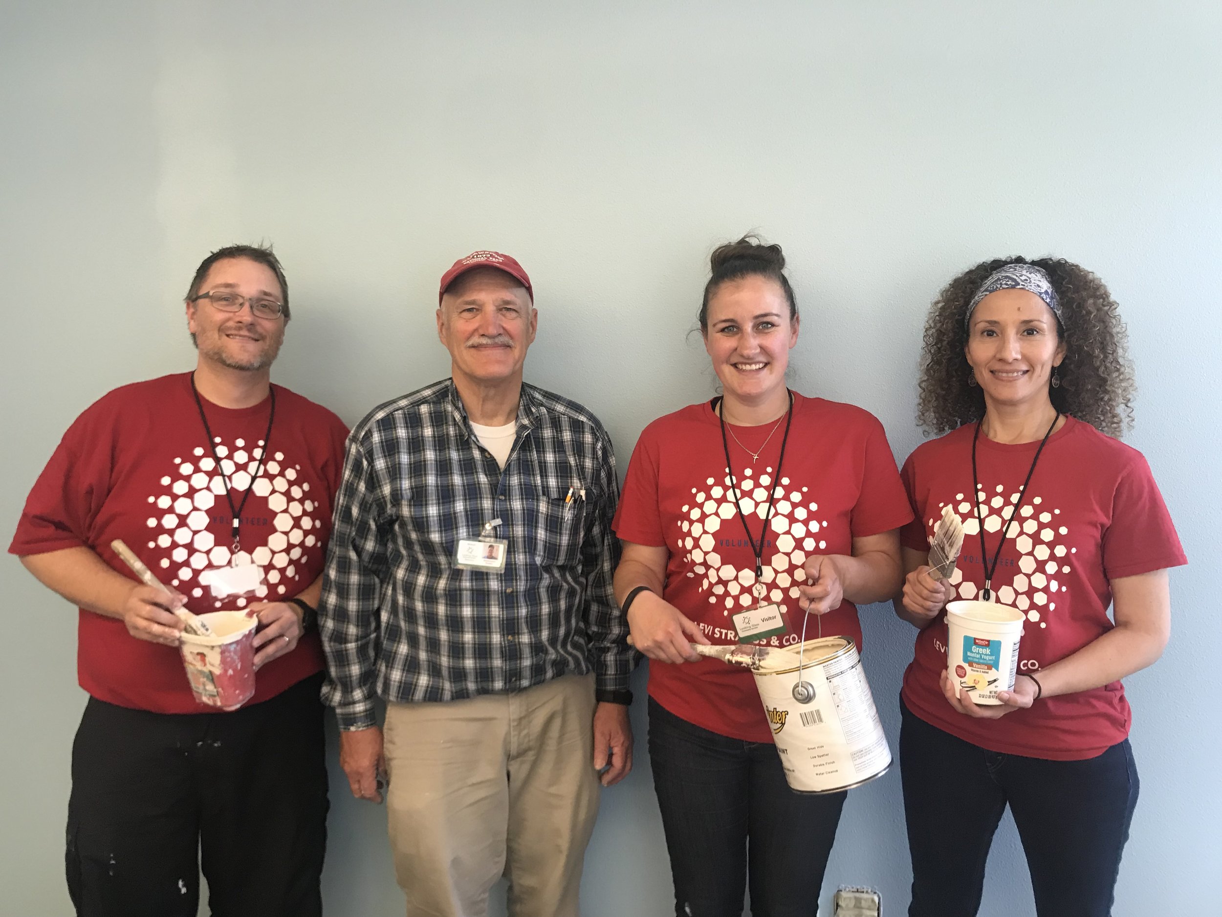  Levi Employees Scott Hanscom, Brianne Emel and Veronica Lockwood join Looking Glass maintenance worker Mike Touchstone in painting a brighter welcoming entrance at the Looking Glass Counseling annex office. 
