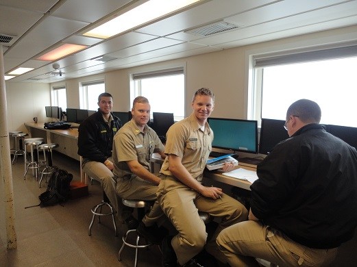 1st Class Cadet Gyle McGurn seen here in the Navigation Lab calculating star time for sights later that night. McGurn is a Lyman Scholarship recipient. Gyle McGurn, a resident of Maui, is seated on far left.