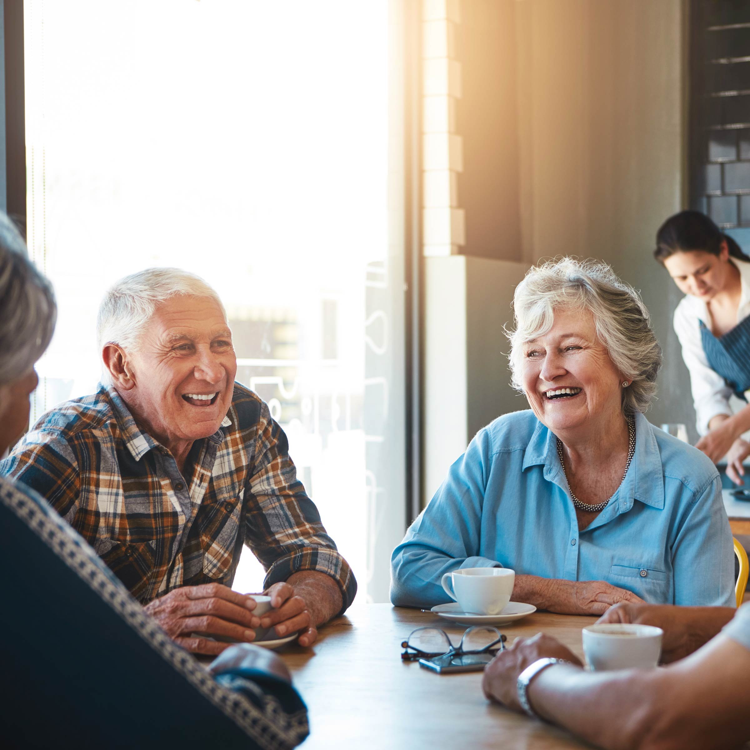 2 older people talking to each other smiling