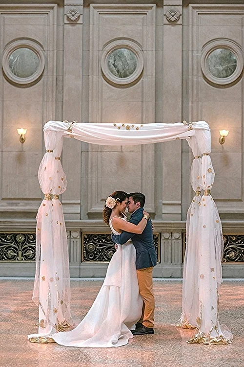 For the chuppah to hold a room as large as this one, I chose bold and delicate materials.