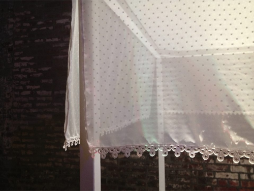 A custom silk canopy with a swiss dot pattern...