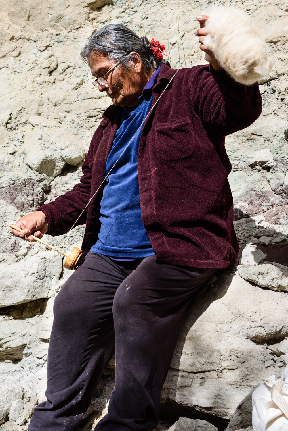 Ron Garnanez spins wool from his Navajo Churro sheep on a hand spindle.