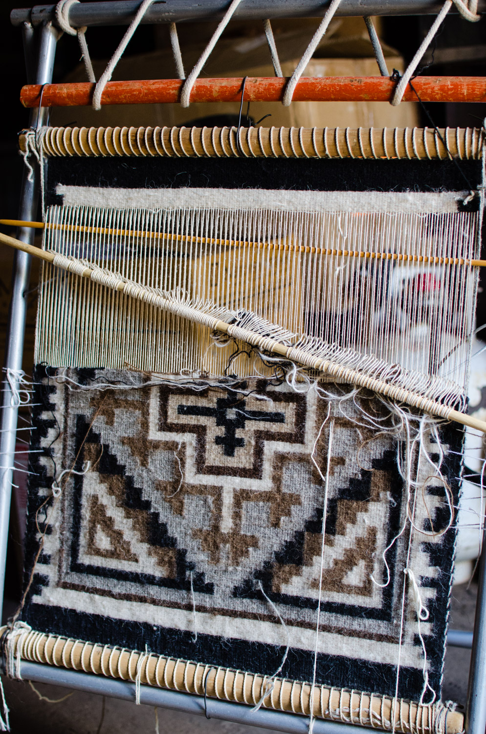 A rug being woven by a Navajo sheep herder from the Toadlena area. 