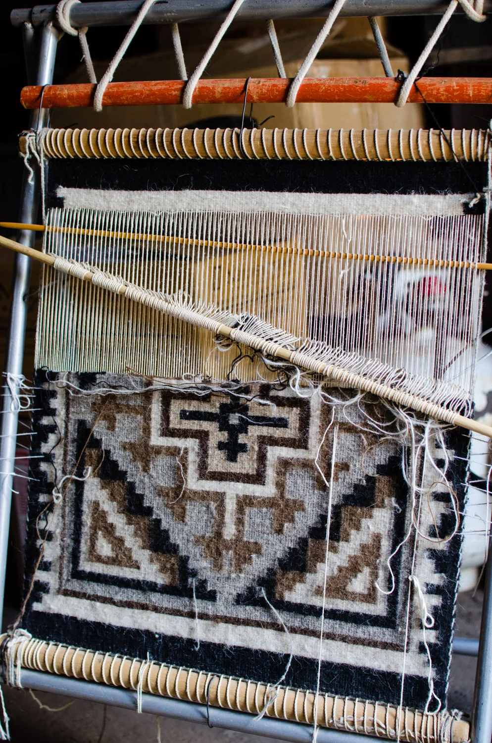 A rug being woven by a Navajo sheep herder from the Toadlena area. 
