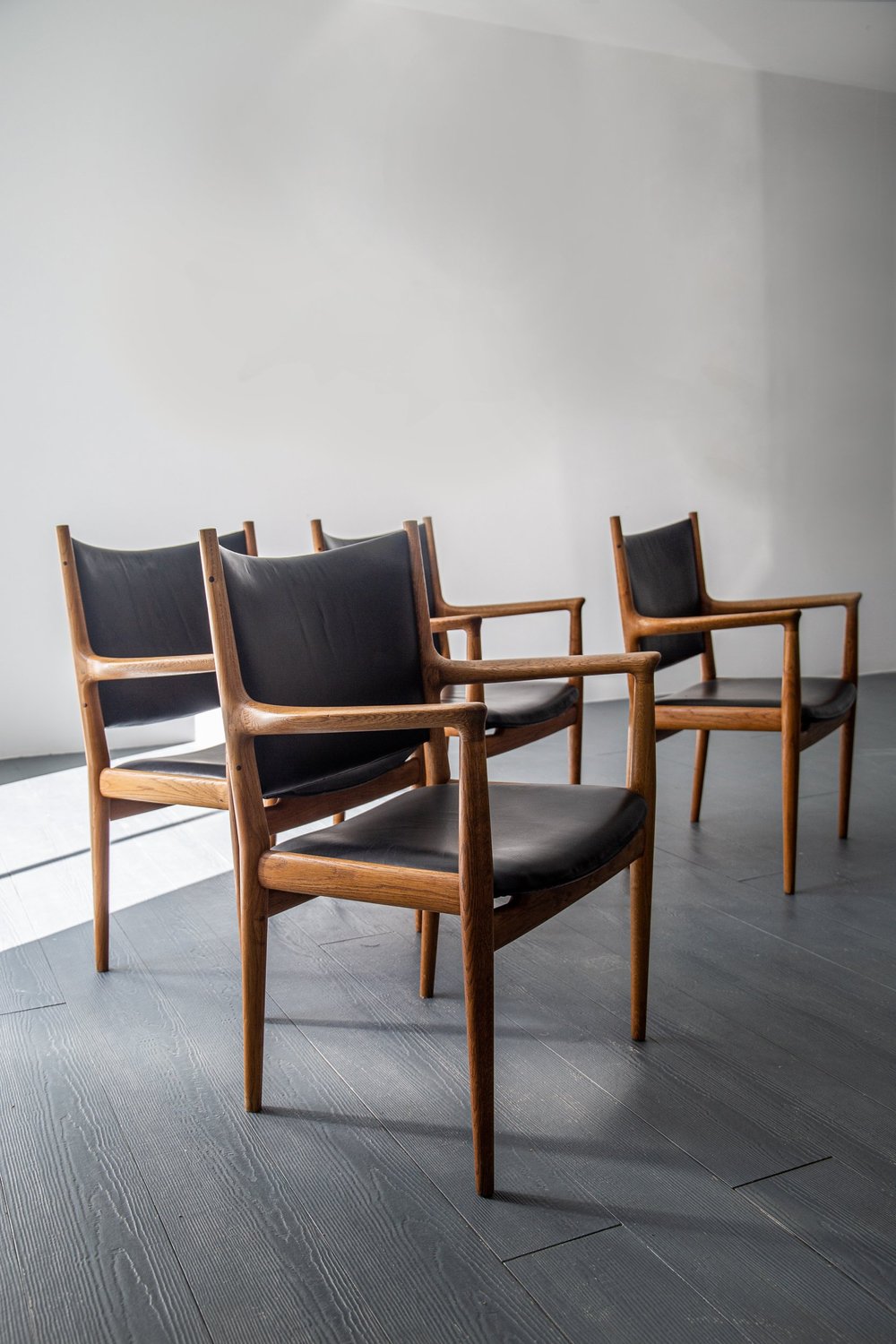 A SET OF FOUR JH513 ARMCHAIRS IN OAK BY HANS WEGNER FOR JOHANNES 
