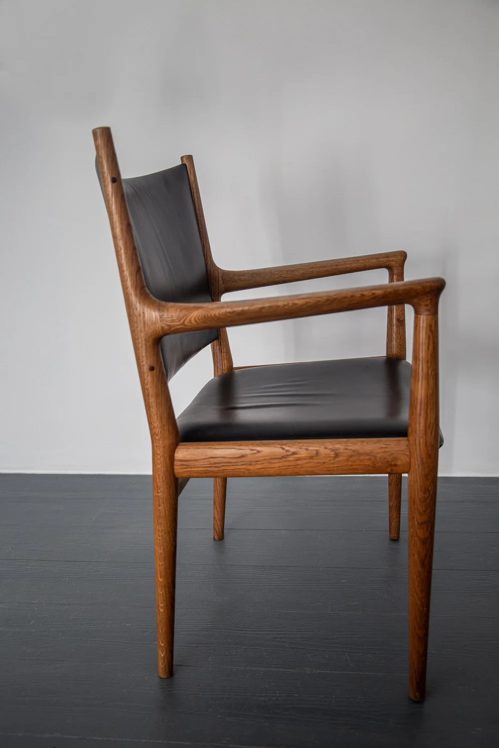 A SET OF FOUR JH513 ARMCHAIRS IN OAK BY HANS WEGNER FOR JOHANNES 