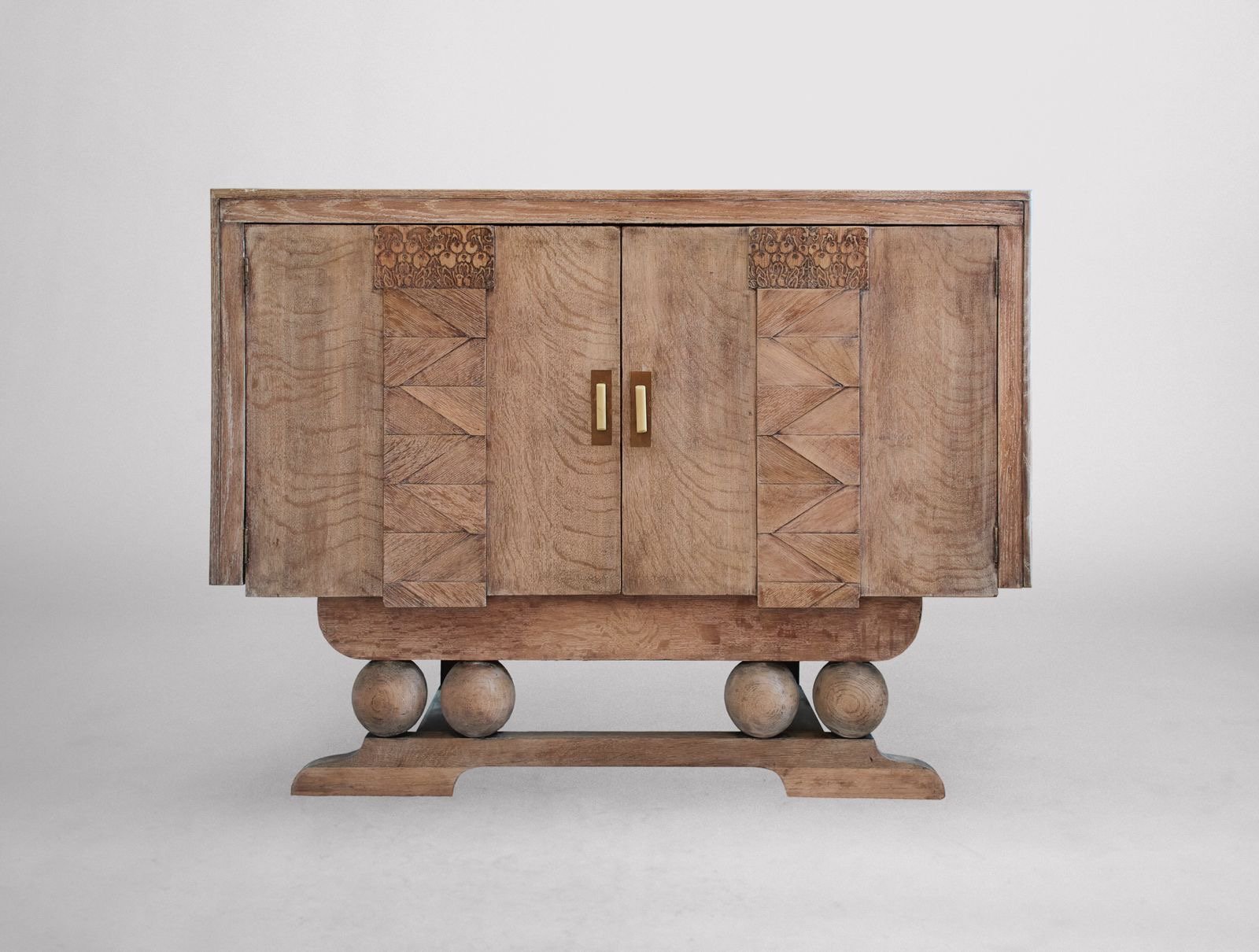 A DISTINCTIVE ENGLISH ART DECO LIMED OAK SIDEBOARD