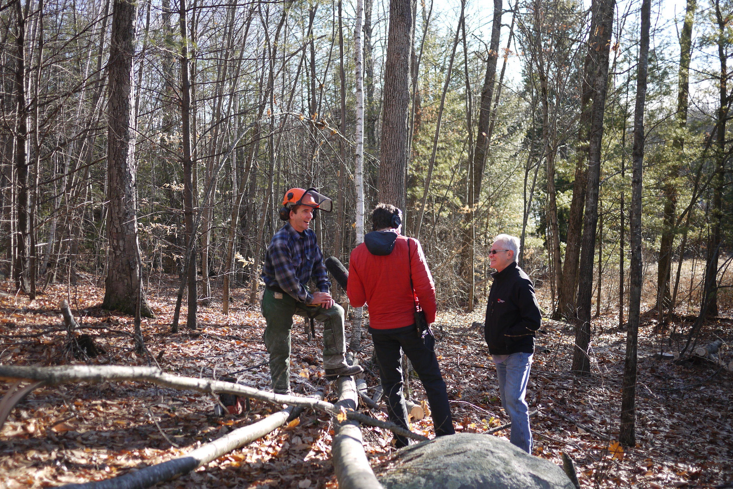 Sam and Art Wolinksy talking to a neighbor who was in the process of cleaning up some of the beaver chewed trees.