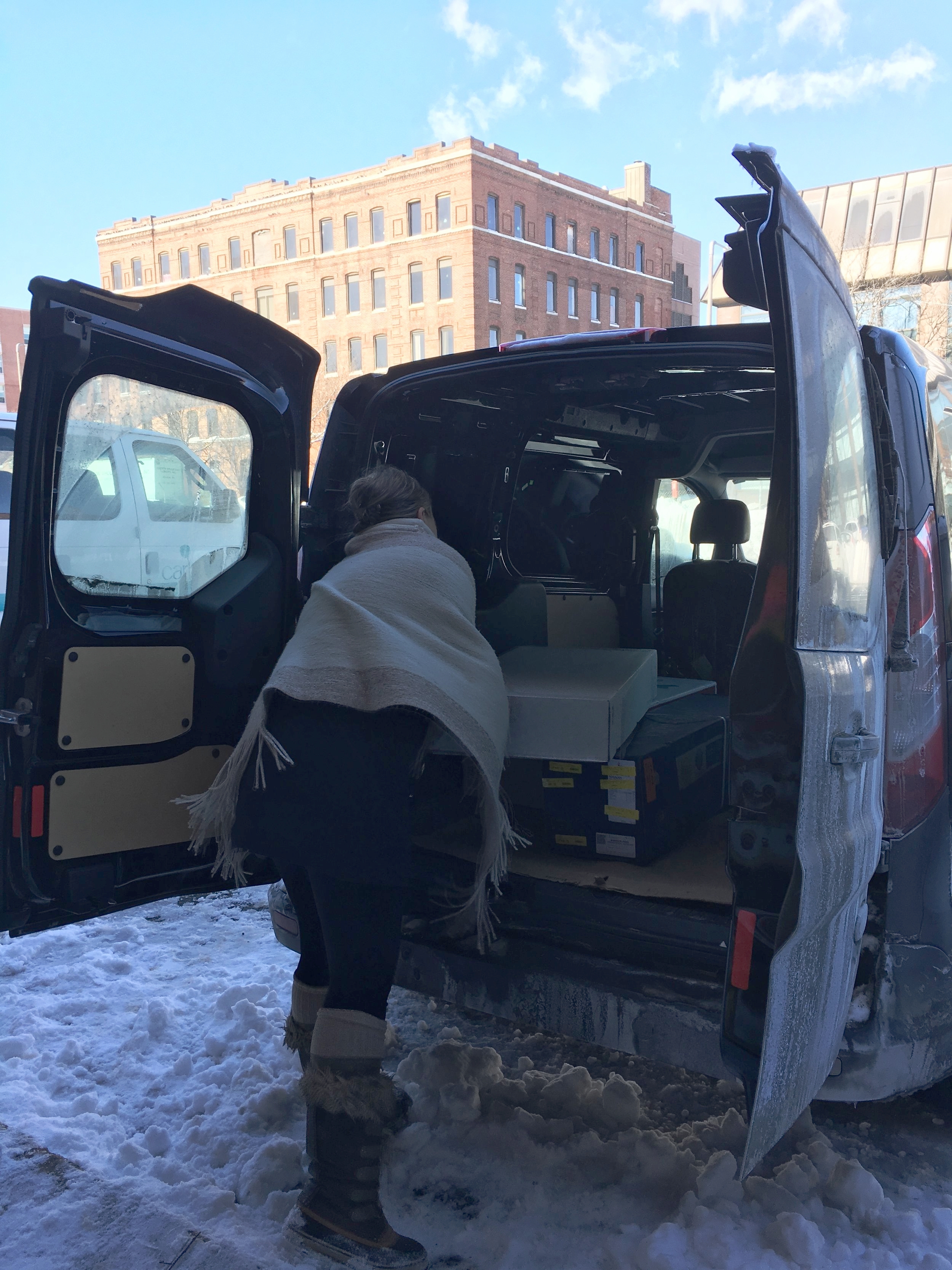 Emily Herzig loads fresh flowers into her van at the Boston Flower Exchange on a cold winter day. | Photo: Molly Donahue