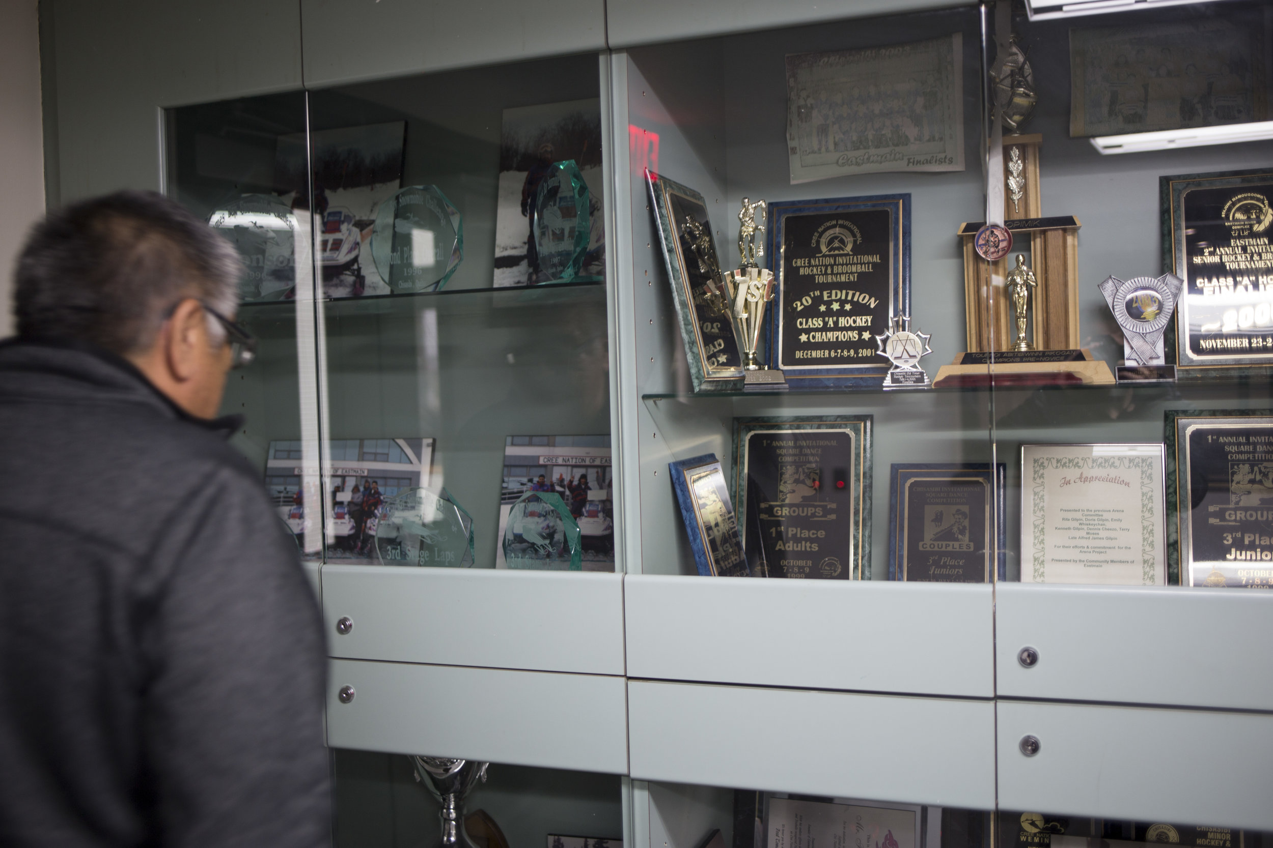  Kenny Gilpin looks for his photo in the trophy case at the Eastmain Community Center 