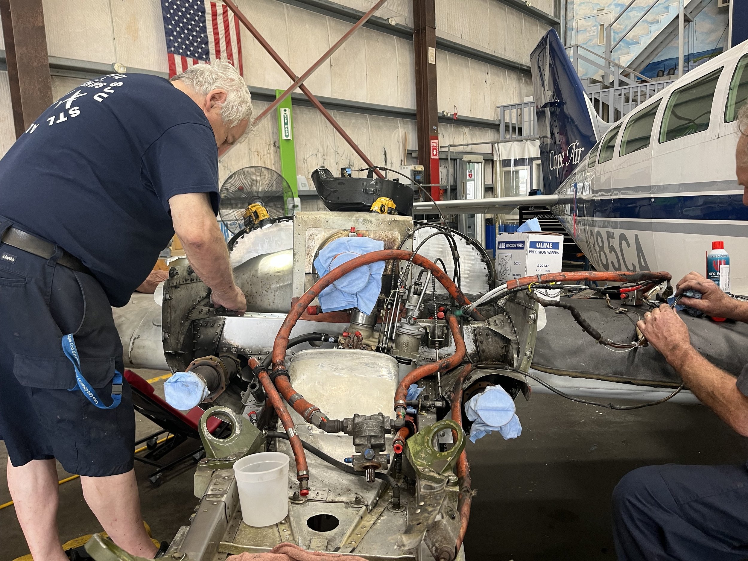  Technicians Joe Urbanski and Scott Genthner working on an engine change. With an electric engines, maintenance like this would be far less frequent. Photo by Justine Paradis. 