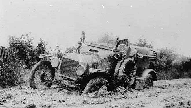  An early car is mired in the mud. Woodward Avenue between Six and Seven Mile became the first mile of concrete highway in the world in 1909. (The Detroit Publishing Co.) 