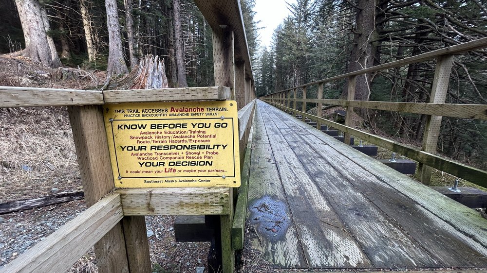  A sign warning Juneau residents about the risk of rockslides and avalanches on a popular hiking trail near downtown. 