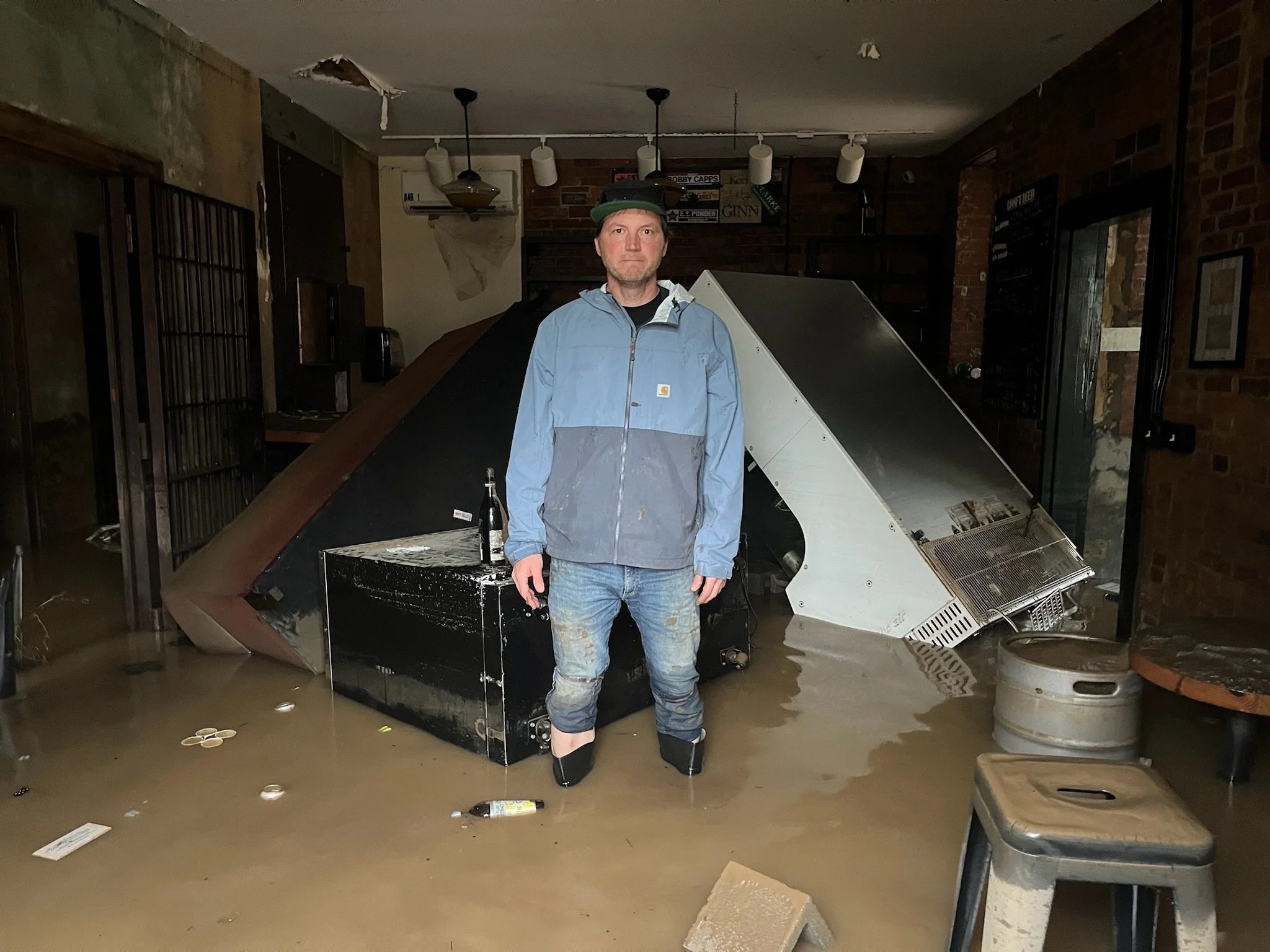  Josh Copus, owner of the Old Marshall Jail Hotel, stands inside his flooded business. Courtesy of Josh Copus. 