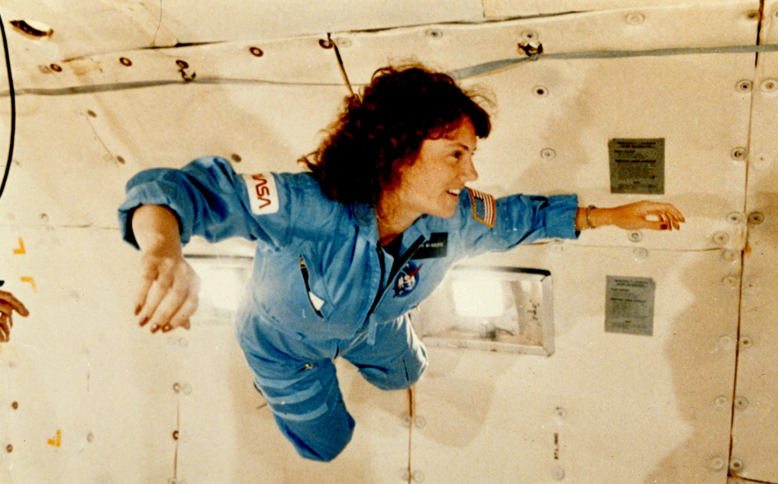 Christa McAuliffe gets a preview of microgravity during a special training flight
