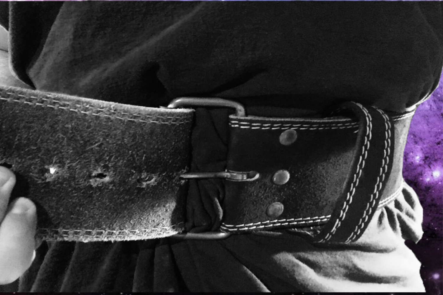 Athlete tightening weightlifting belt.PNG