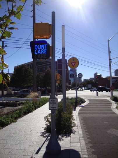 Care/Don’t Care, 2010 By Jamie Pawlus (Indianapolis) Custom pedestrian crossing signal, approx. 12 ft. tall. Location: East end of Mass Ave, just east of College Avenue. Placed out of functional context in mid-block, pedestrians are encouraged to push the signal button to change the artwork’s message to either “Care” or “Don’t Care,” messages which also change at random intervals without requiring any intervention. The artwork is intended to have an immediate effect on those who encounter it, as it asks them to participate in acknowledging their current state of mind at any given moment. The artist, Jamie Pawlus, is an Indianapolis resident whose work consists of repurposing objects of daily use and turning them into statements of social relevance.