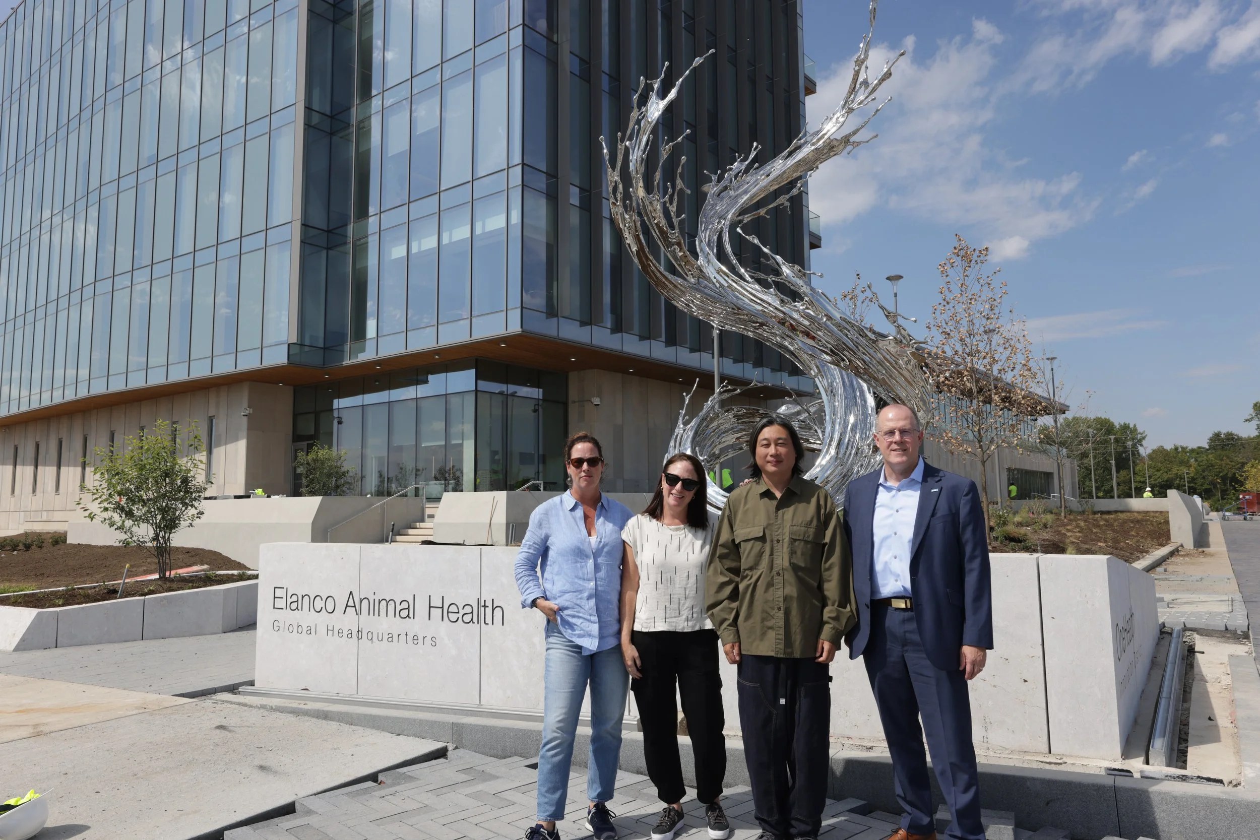  Artist Zheng Lu stands next to the finished sculpture with Art Strategies owner and chief curator, Mindy Taylor Ross, Sundaram Tagore Gallery director Susan McCaffrey, and Elanco executive vice president Dave Kinnard.  