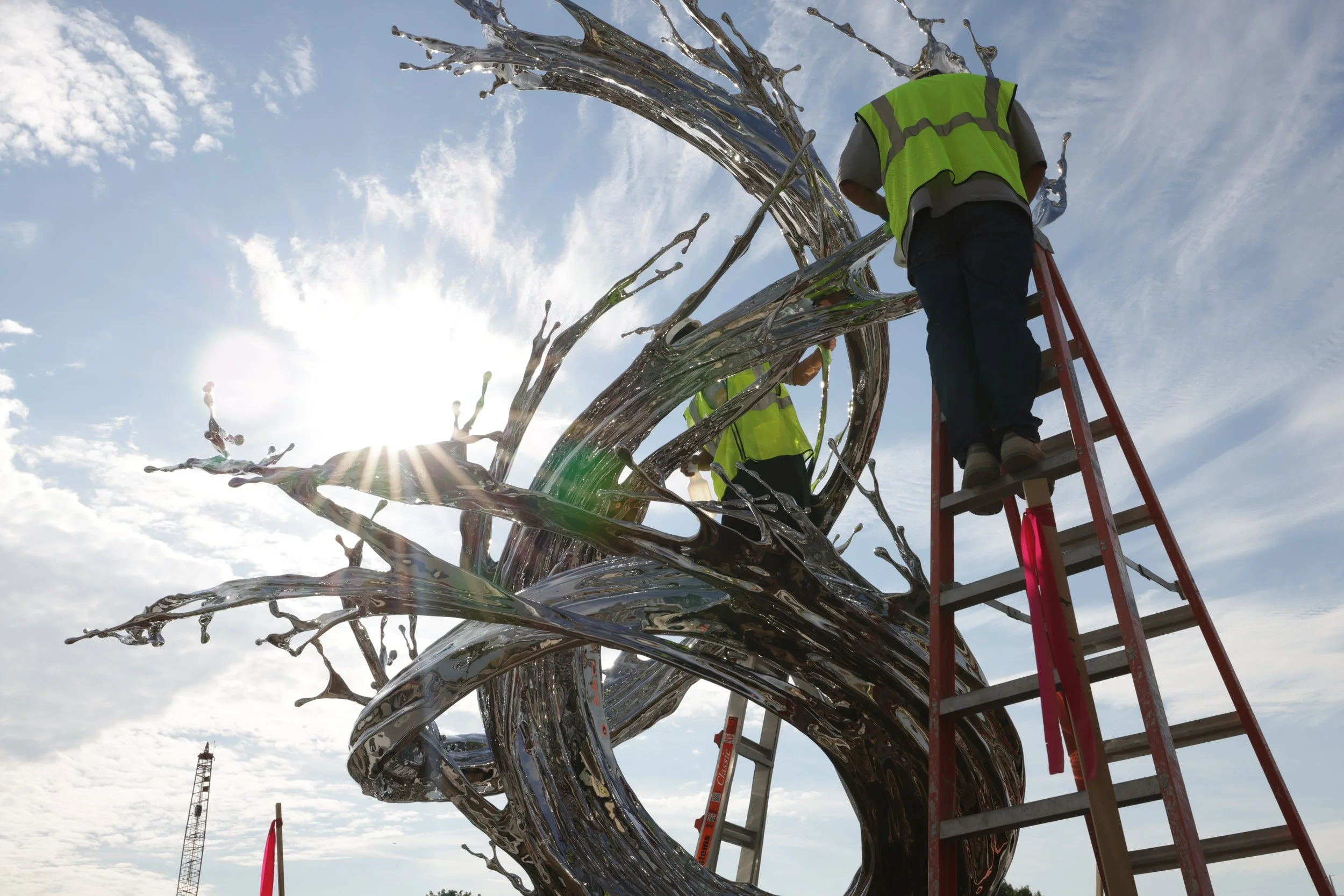  Artist Zheng Lu and his team from Beijing polishing and preparing the high polished stainless steel sculpture. 