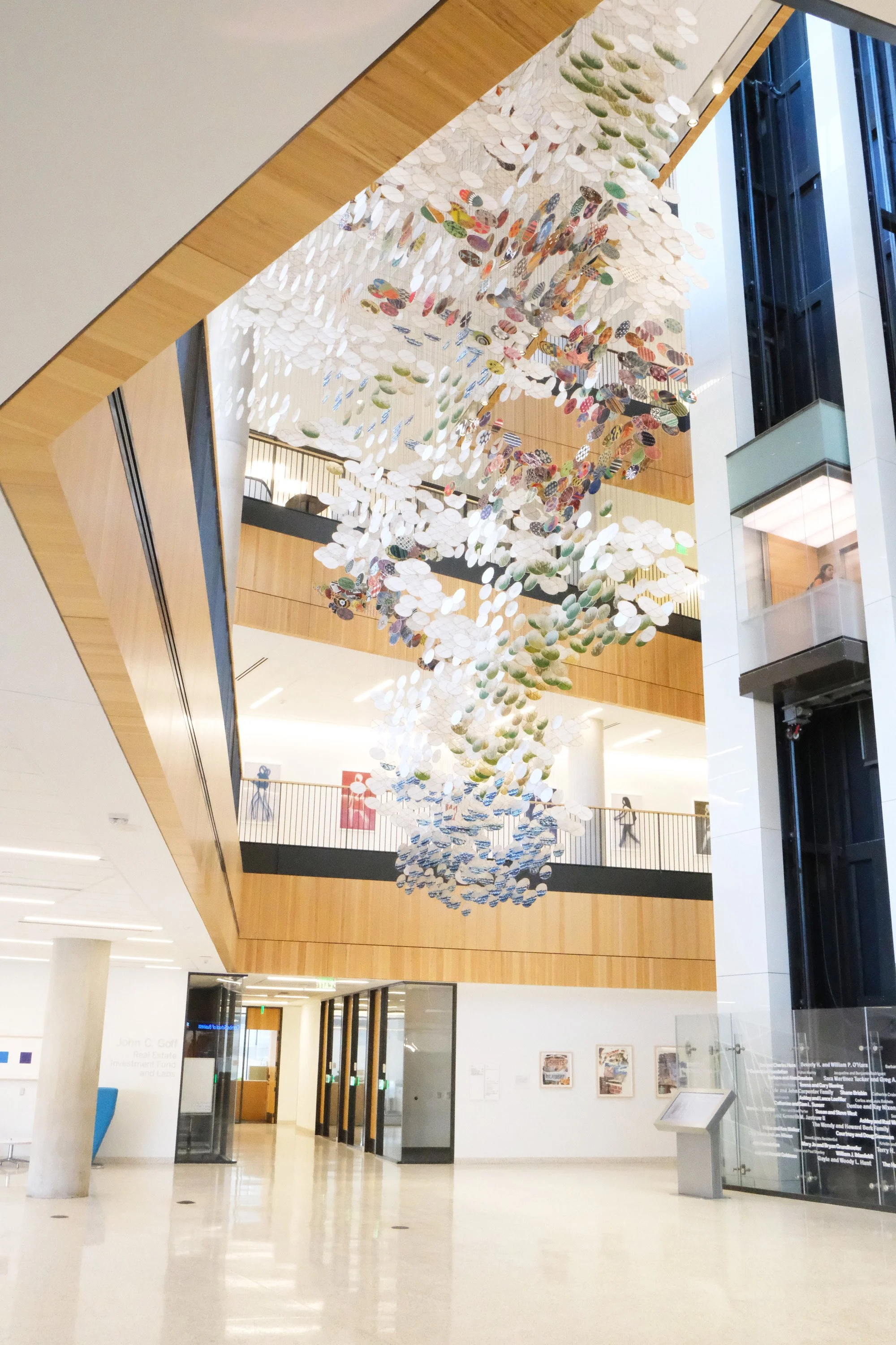  The piece interacts with all the artworks hanging in the building's public spaces. It is part of a collection of 71 works by 23 artists, generously underwritten by Carolyn and Preston, UT ’62, Butcher.  View from the atrium lobby of the installation