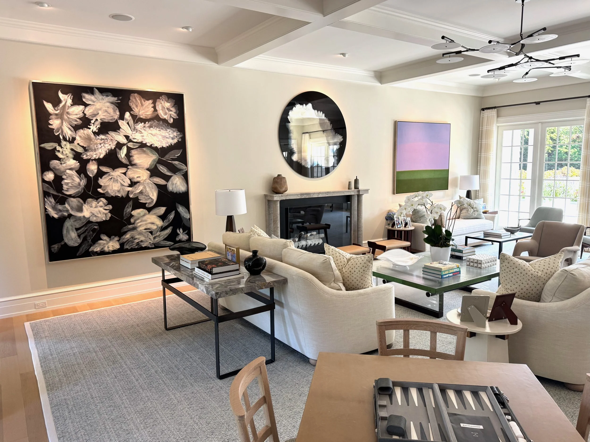  In the more formal living room that looks out onto the outdoor entertainment space and pool, one finds a pair of beautiful tonal paintings. The large painting is by Ross Bleckner and the smaller is a painting by Susan Vescey. Both artists are associ
