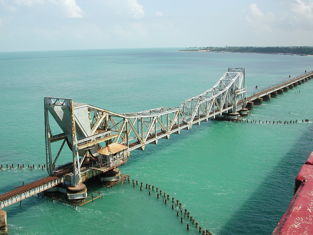 The Pamban Bridge is a railway bridge on the Palk Strait which connects the town of Rameswaram on Pamban Island to mainland India. The bridge refers to both the road bridge and the cantilever railway bridge, though primarily it means the latter. Opened on 24 February 1914, it was India's first sea bridge, and was the longest sea bridge in India until the opening of the Bandra-Worli Sea Link in 2010. The rail bridge is, for the most part, a conventional bridge resting on concrete piers, but has a double leaf bascule section midway, which can be raised to let ships and barges pass through.