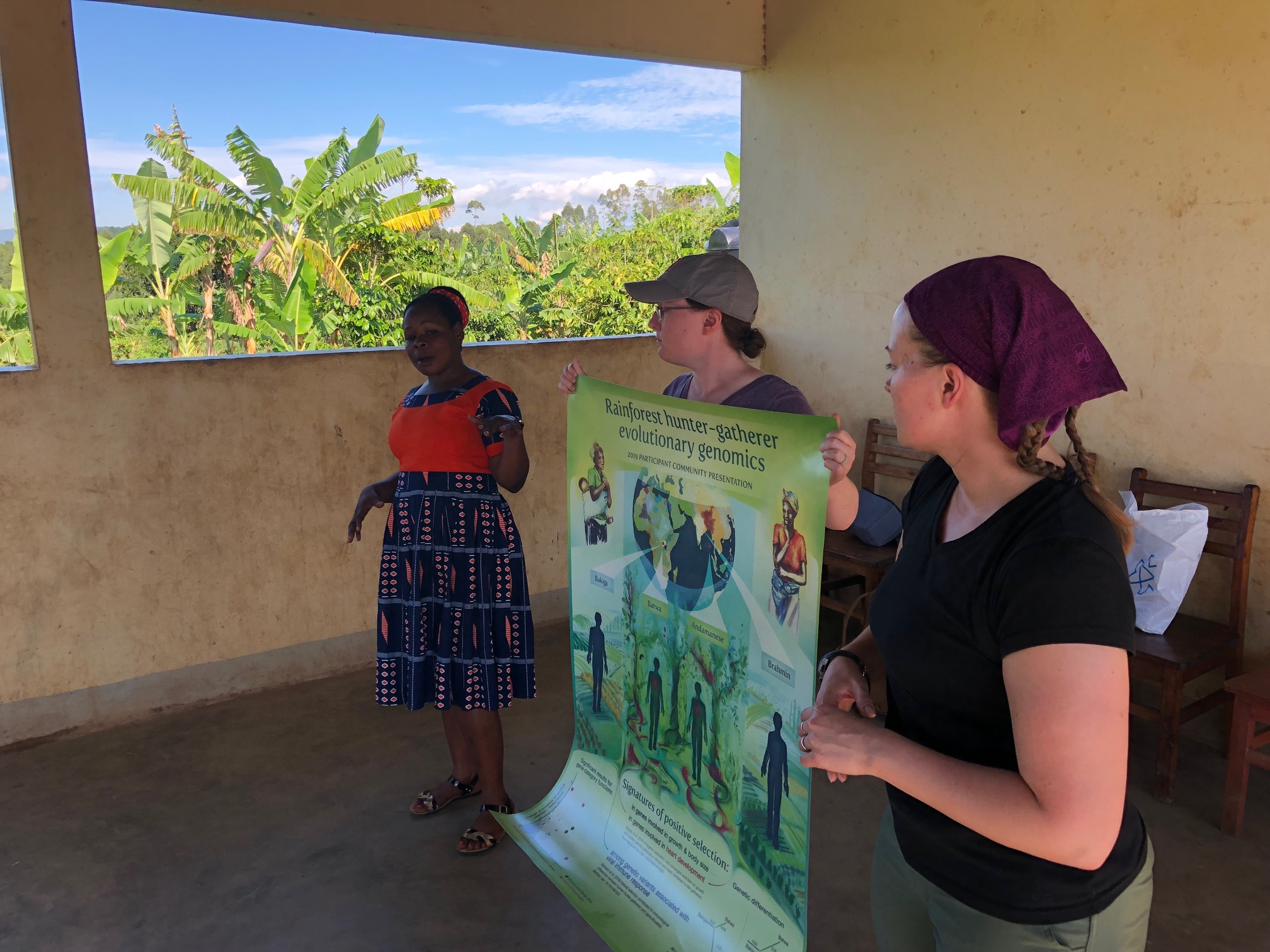 Lab postdocs Katie Grogan and Christina Bergey, with Sylvia Kokunda from the Batwa Development Program, presenting results from our hunter-gatherer genomics research to Batwa participant communities. 