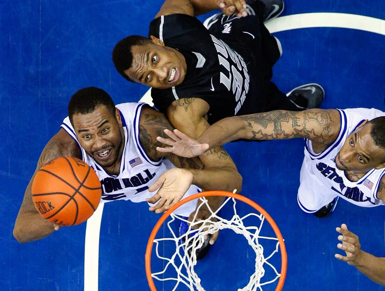 Seton Hall Pirates center Eugene Teague, left, and Seton Hall Pirates forward Brandon Mobley, right, battle Long Island Blackbirds forward E.J. Reed (33) for a rebound on Dec. 5, 2013, at the Prudential Center. Seton Hall defeated LIU, 92-81. (Photo Credit: Saed Hindash)