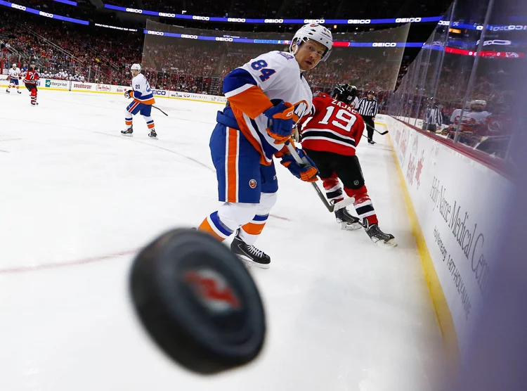 New York Islanders center Mikhail Grabovski (84) eyes the puck as it flies around the boards against the New Jersey Devils during the first period at the Prudential Center. Newark, NJ. 1/9/15 (Photo Credit: Saed Hindash)