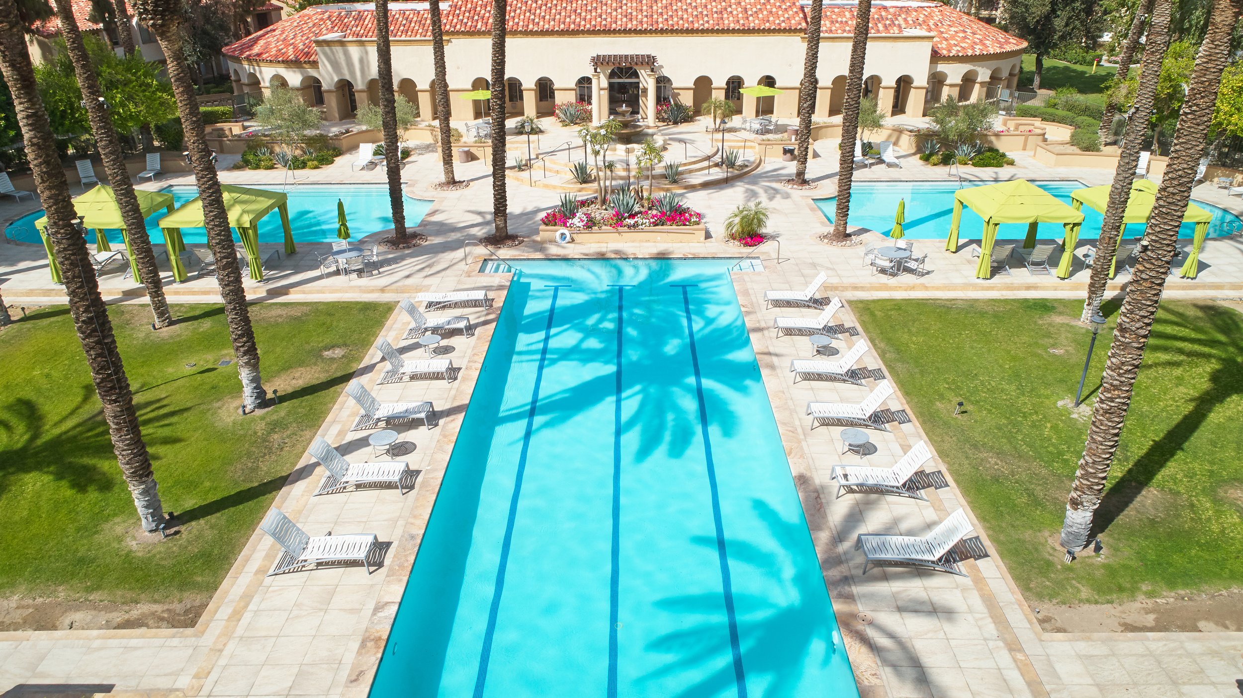  Gorgeous resort-style pool area at The Regent equipped with comfortable lounge chairs, and cabanas designed for a luxurious experience.  