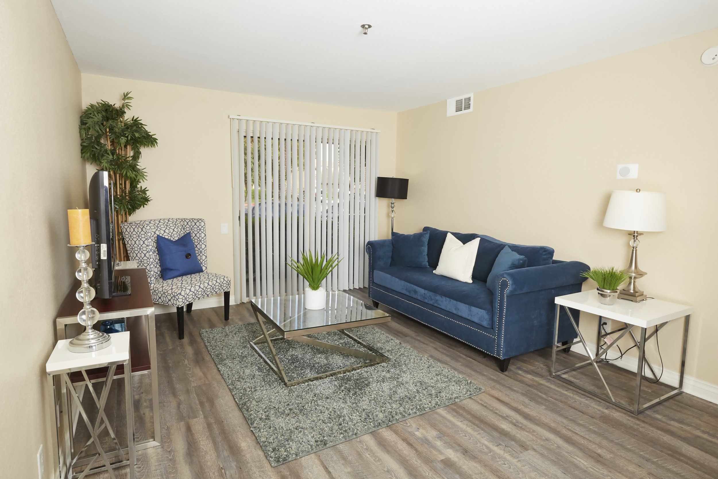  Spacious living room with plank flooring throughout and an entrance to your private patio 