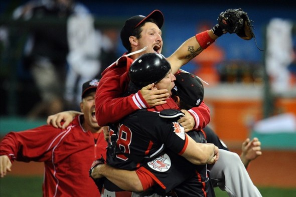 Canada defends its Pan Am gold starting July 11 against the Dominican Republic at the President’s Choice Pan Am Ballpark two diamonds in Ajax, Ont. The first women’s event begins July 20 as Canada opens against Cuba. DH Chris Robinson (Dorchester, Ont.) hugs C Cole Armstrong (Surrey, BC) after Scott Richmond (North Vancouver, BC) struck out the final hitter for the 2-1 win. ….