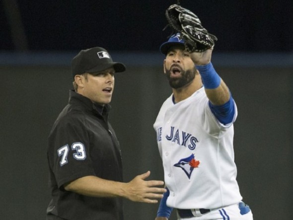 Jose Bautista replies to Adam Jones and the rest of the Baltimore Orioles dugout. Ump Trip Gibson stands between Bautista and the Orioles. Moments later the Blue Jays right fielder tried to throw out Delmon Young at first base, re-aggravated his arm and has not played since.