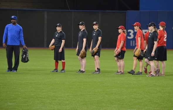 Canada’s women team began preparing for the Pan Am Games competition next month in Ajax with an intra-squad game at the Rogers Centre on Monday. Outfielders, like Autumn Mills (first in line in red) were given pointers by former Gold Glove winner Devon White. Photo: Alexis Brudnicki