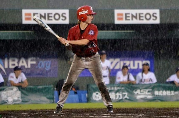 2B Nicole Luchanski (Edmonton, Alta.) is a woman for all seasons shown here hitting in the wet of the Worlds championship at Miyazaki, Japan. Luchanski has had help on her way to the Pan Am Games this summer in July. Photo: Alexis Brudnicki.